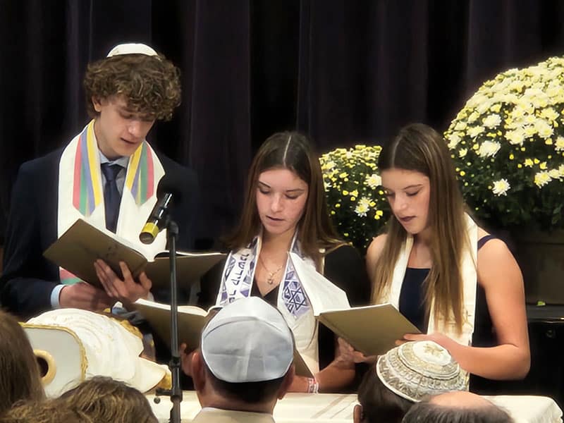three teenagers singing